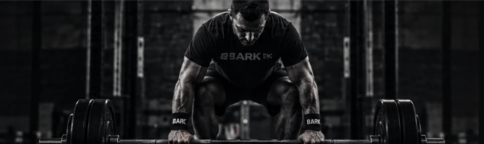 Athlete lifting a loaded barbell on the gym floor